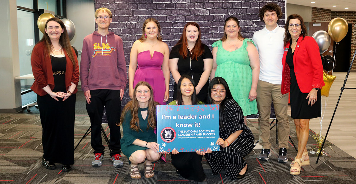 NSLS group holding sign that reads I'm a leader and I know it!